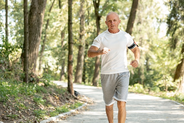 Old man running in the woods