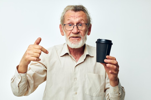 Old man in a shirt and glasses a black glass light background