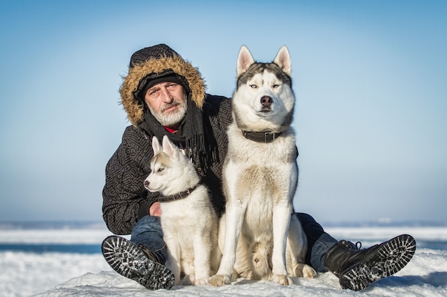 Old Man and sled dogs on an ice floe.