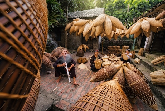 Old man smoking with Group of Old Vietnamese female craftsman