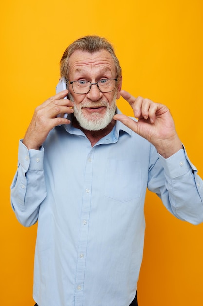 Old man talking on the phone posing closeup unaltered