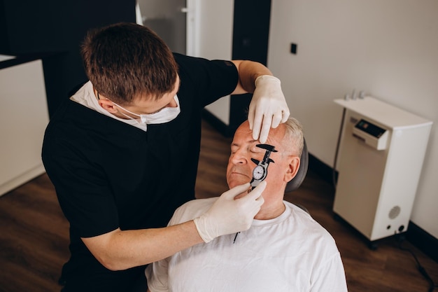 Old man visiting male doctor for plastic surgery