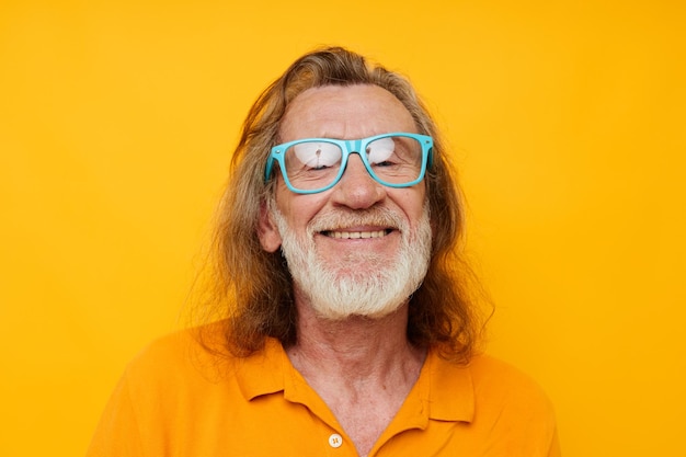 Old man wearing blue glasses yellow tshirt