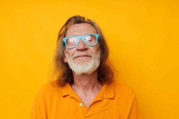 Old man wearing blue glasses yellow tshirt