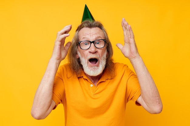 Old man wearing glasses green cap on his head holiday emotions\
isolated background