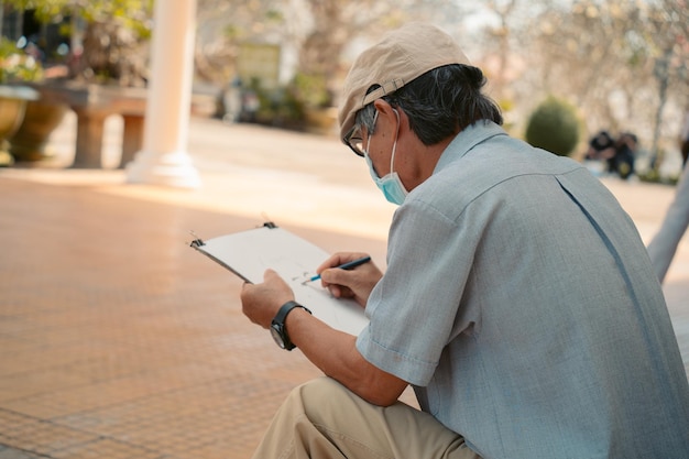 Old man wearing medical mask painter creating picture of boy\
art talent craft hobby occupation