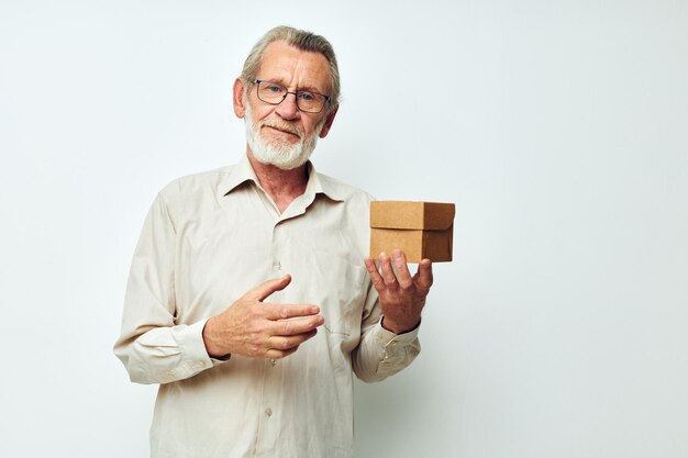 Old man with glasses demonstrates a box in studio one