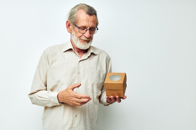 Old man with glasses demonstrates a box in studio one