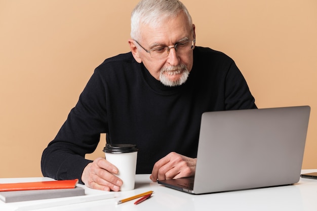 Old man with laptop portrait