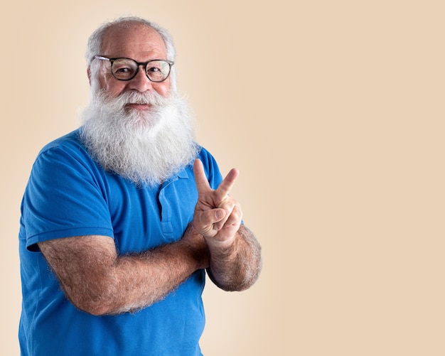 Old man with a long beard on a pastel background. Senior with full white beard.