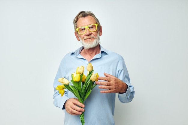 Old man yellow bouquet of flowers posing isolated background