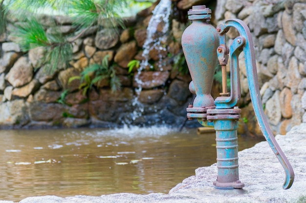 Old manual water pump close up