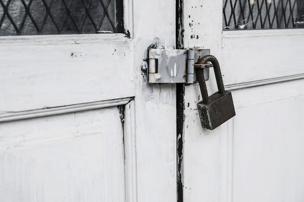 Old master key at white wooden door