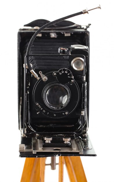 Old mechanical photo camera on a white background