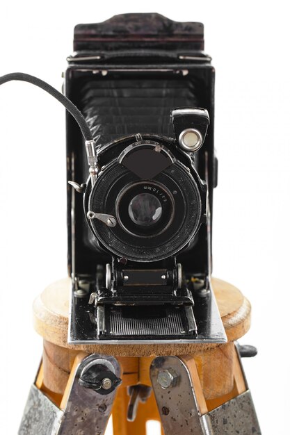 Old mechanical photo camera on a white background