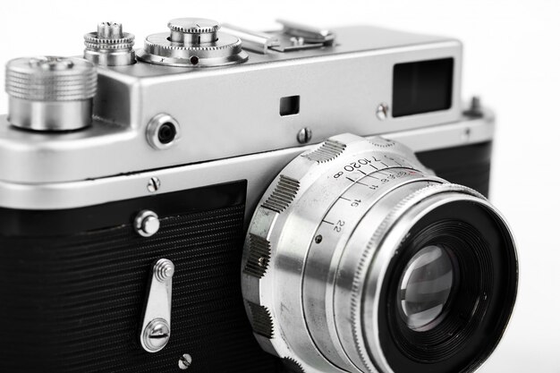Old mechanical photo camera on a white background