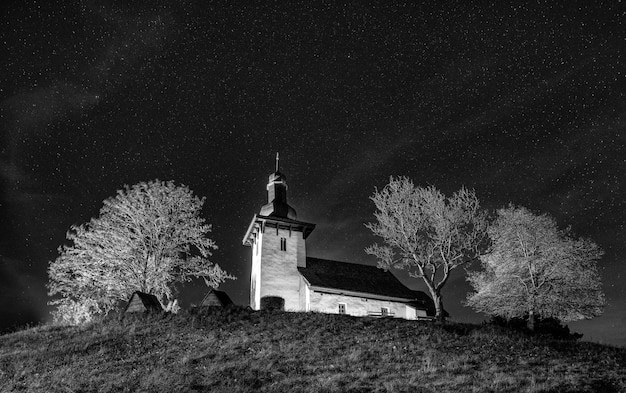 Old medieval church at night with stars in the sky Church of St Martin in Martincek Slovakia
