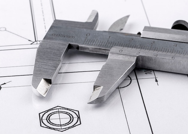 Old metal caliper and engineering drawing