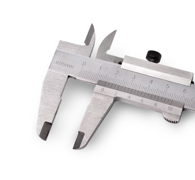 old metal calliper cut out on white surface