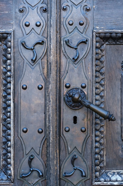 Old metal door handle on the old door