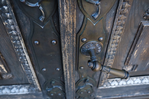 Photo old metal door handle on the old door.