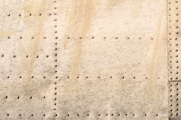 Old metal silver surface of the aircraft fuselage with rivets