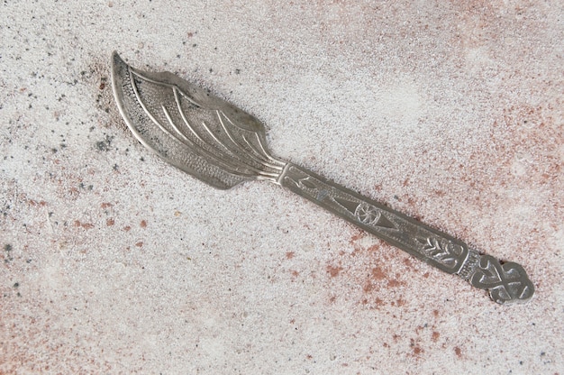Old metal spatula on concrete background. Food photography props