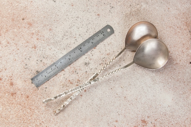 Old metal spoons on concrete