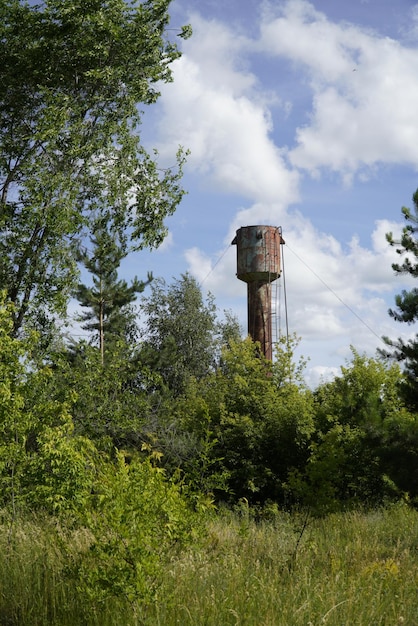 An old metal water tower among dense vegetation Ulyanovsk Russia