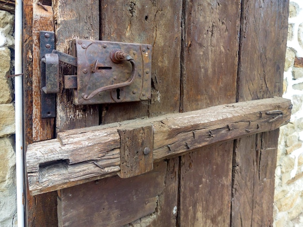 Old metal and wood lock of a wooden door Close up