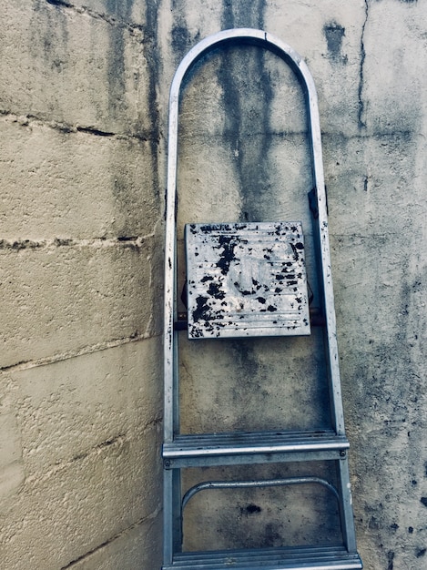 Old metallic ladder on the wall in the street