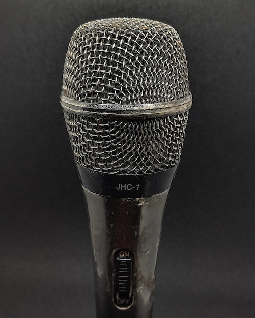 Old microphone on a black background