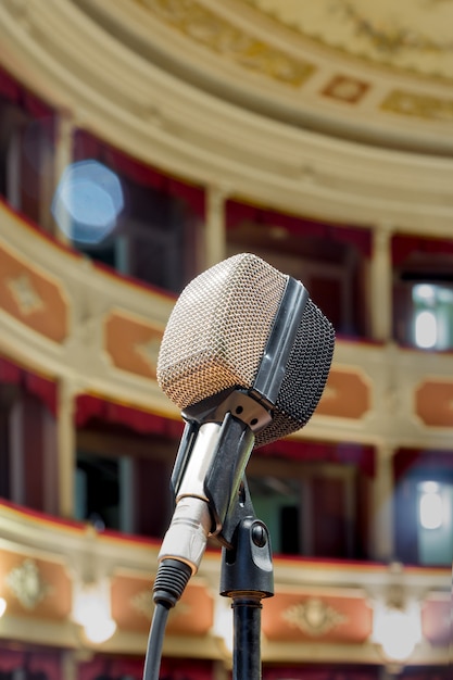 The old microphone waiting for the live performance of the singer in the ancient theater.