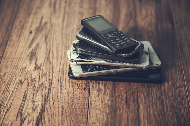 Old mobile phones on a table background