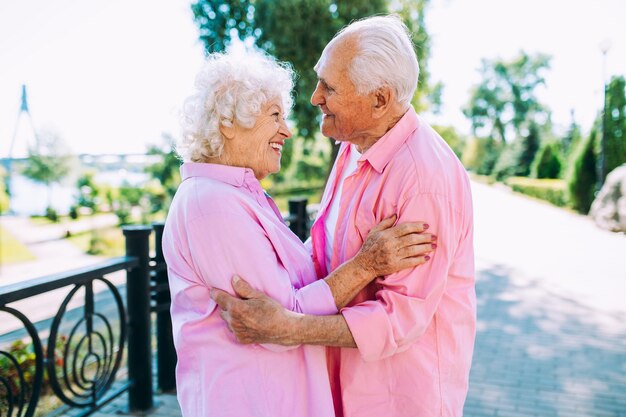 Old modern couple dressing fashionable colored clothes