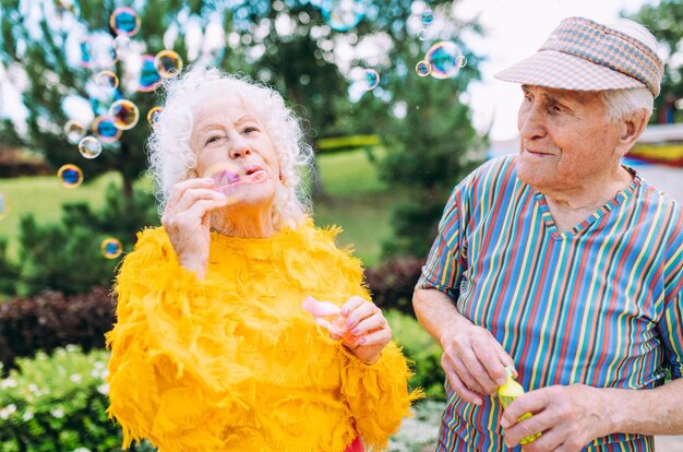 Old modern couple dressing fashionable colored clothes