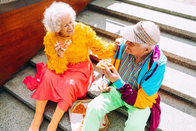 Old modern couple dressing fashionable colored clothes