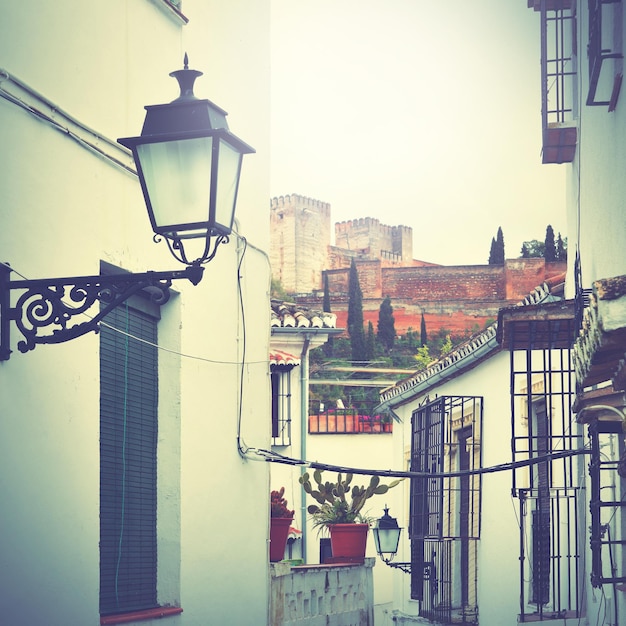 Old narrow street in Granada, Spain. Retro style filtred