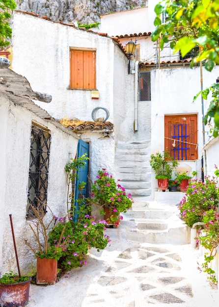 Old narrow street with flowers in Anafiotika Plaka district Athens Greece Plaka is tourist attraction of Athens