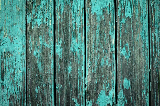 Old natural weathered wooden planks with cracked blue paint background