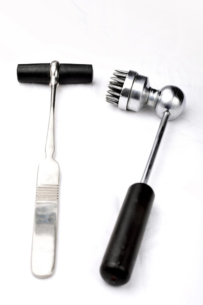 Old neurologist's malleus and  acupuncture hammers for chinese plum therapy on a white background