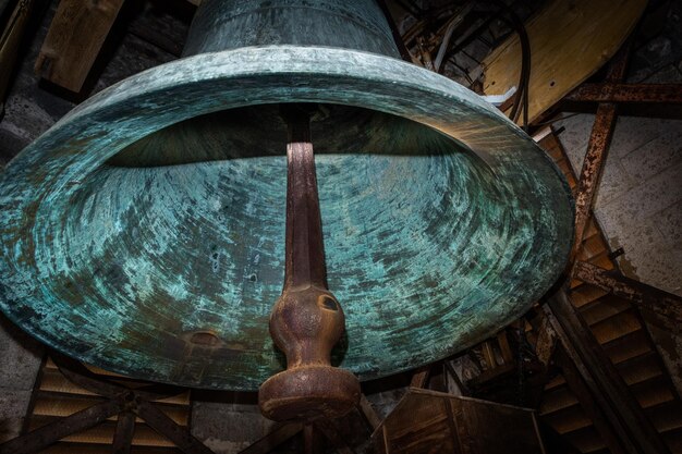 Old and nice bell in a french church with wooden belfry