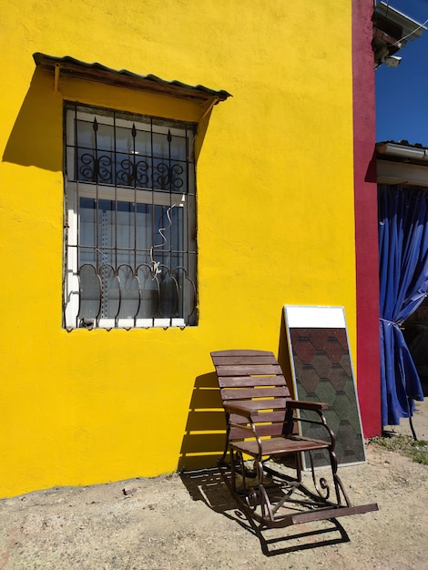 An old old house with a rocking chair