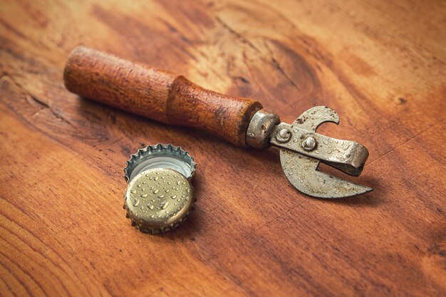 Old opener tool and beer caps