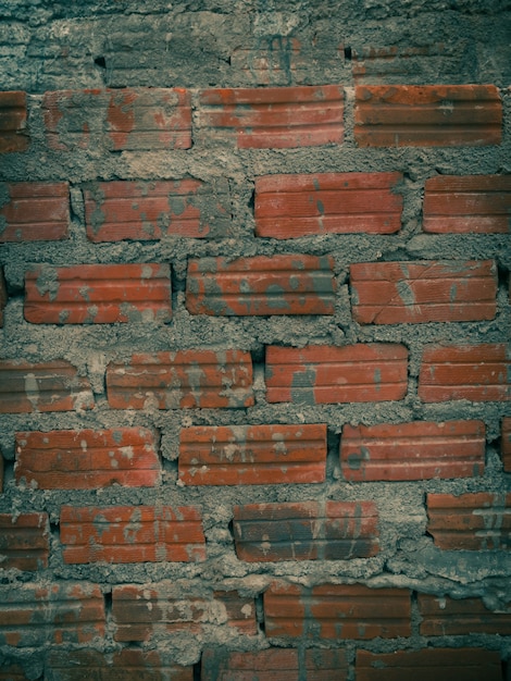 Photo old orange brick wall texture and background, vertical, cinematic tone filter