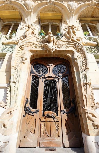 Old ornate door in Paris typical old apartment buildiing