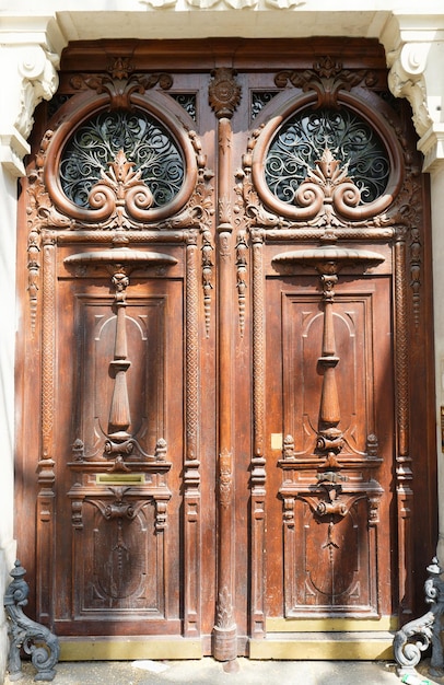 Old ornate door in Paris typical old apartment buildiing