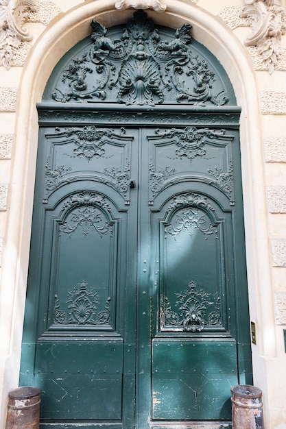 Old ornate door in Paris typical old apartment buildiing