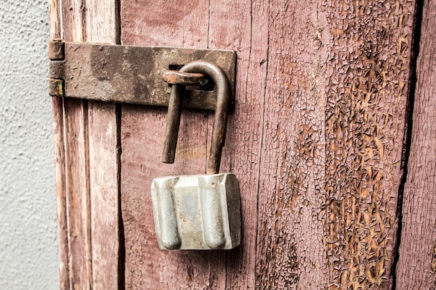 Old padlock on a background of a wooden door