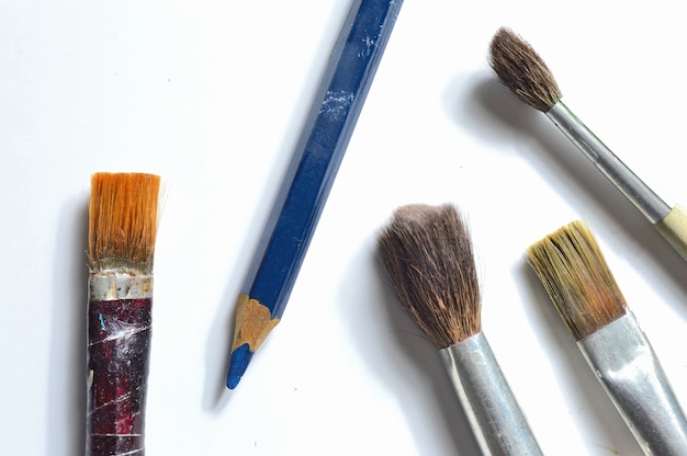 Old paint brushes on white